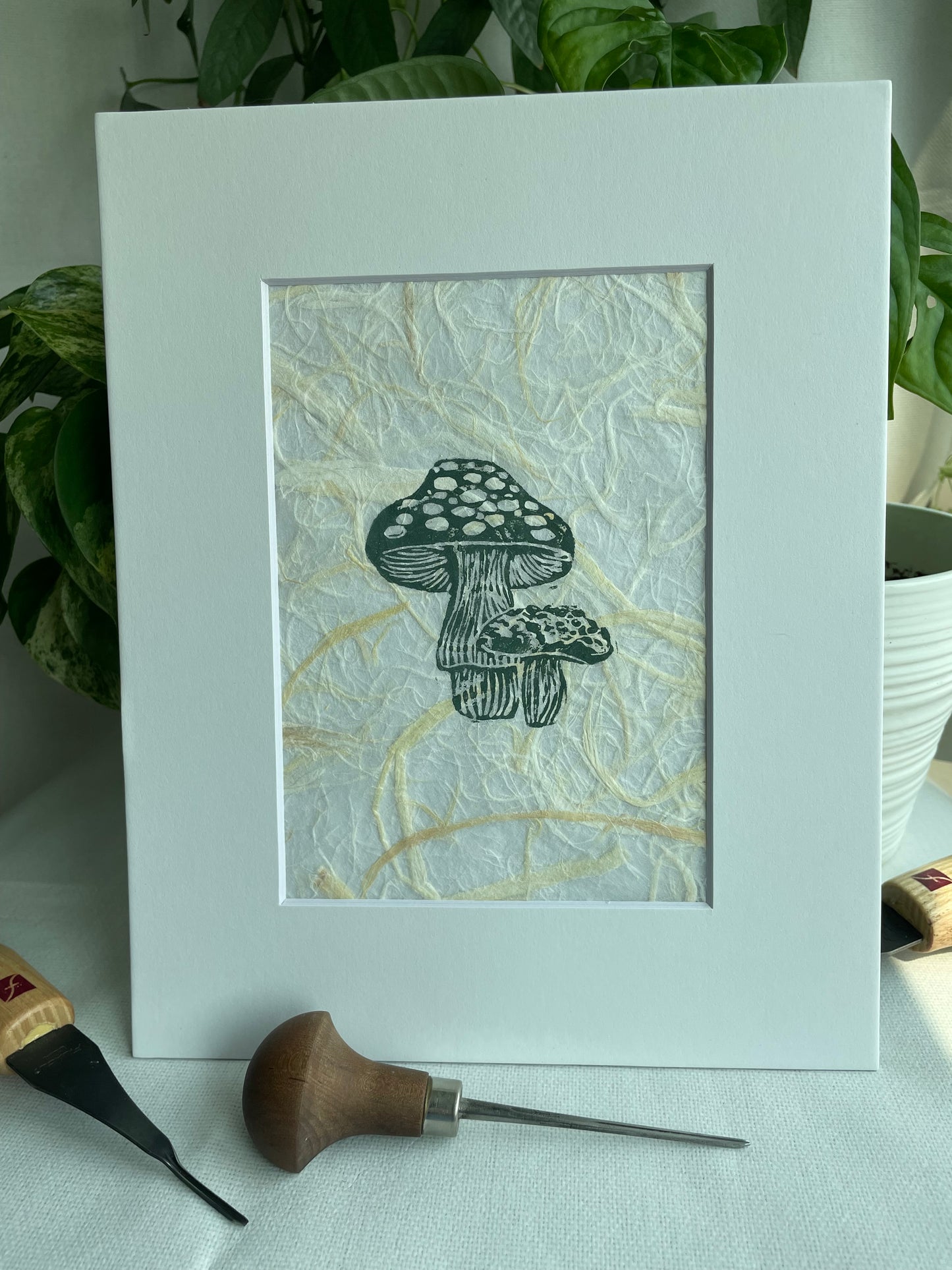 Mini Mush linocut printed on handmade plant fiber paper matted to 8x10”