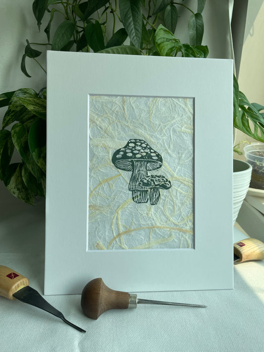 Mini Mush linocut printed on handmade plant fiber paper matted to 8x10”